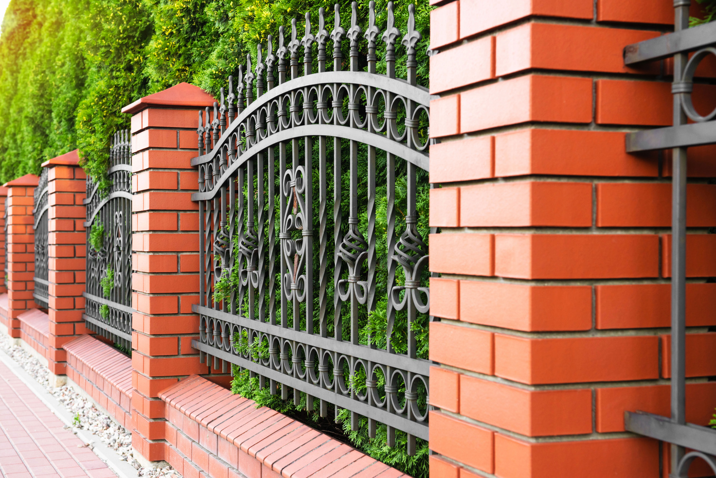 Beautiful Brick Fence with Iron Railing Outdoors